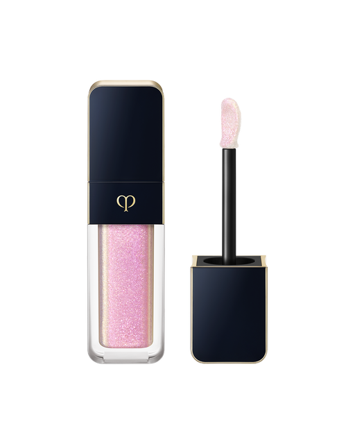 Photo of "CREAM ROUGE SPARKLES", with a blue-black cap engraved with the brand logo and a transparent body. The cap includes an applicator with a precision tip. SHADE: 303.