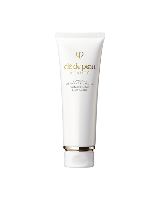 Photo of a white tube container of “SKIN-REFINING CLAY SCRUB”, with brand logo and product name printed in gold on the front.