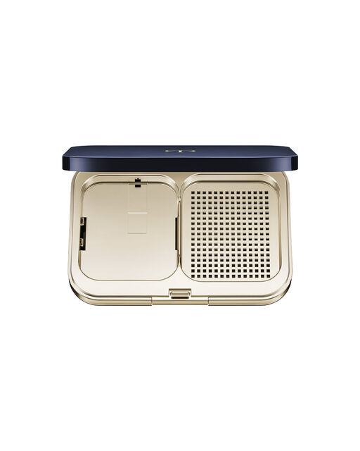 Photo of an exclusive case for "RADIANT POWDER FOUNDATION (REFILL)" with the lid open. The left side holds the refill, while the right side features a breathable compartment for the puff. The interior is finished in gold.