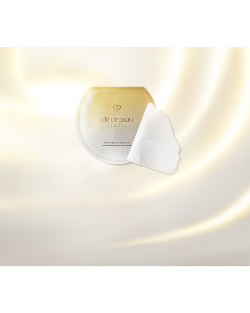 Photo of an eye mask sheet and its packaging placed beside it. The background features an elegant gold gradient.