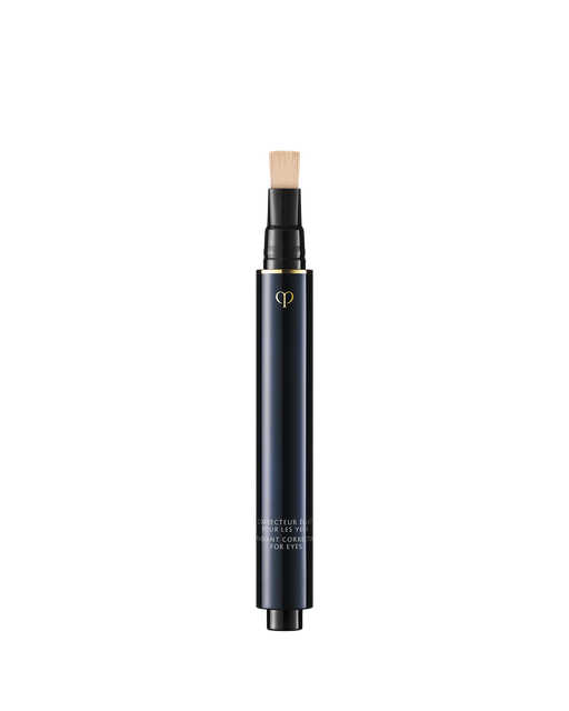 Photo of "RADIANT CORRECTOR FOR EYES", a sleek, blue-black pen-style concealer with a built-in flat brush applicator on top. Shade: Ivory.