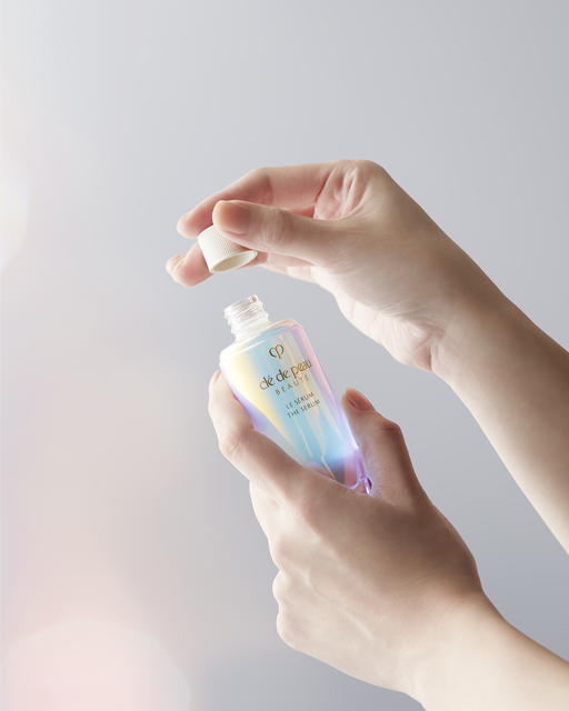 Photo of hands opening a bottle of "The Serum."