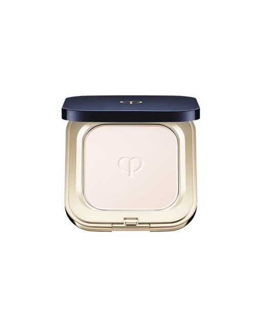 Photo of "REFINING PRESSED POWDER", set in a square compact featuring a blue-black lid with gold trim. The powder features the brand logo embossed at the center.