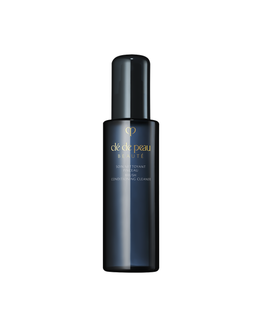 Photo of "BRUSH CONDITIONING CLEANER", which comes in a translucent blue-black bottle engraved with the gold brand logo.