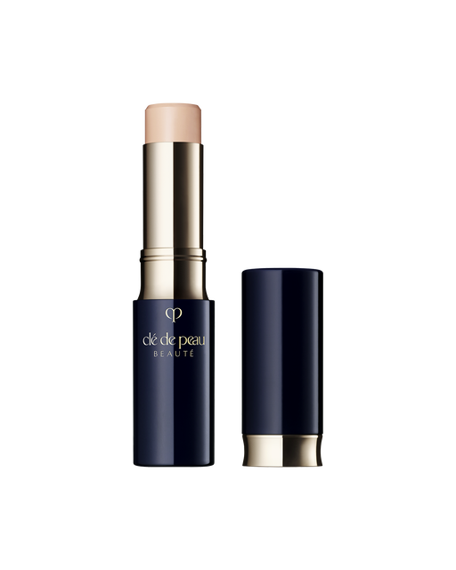 Photo of "CONCEALER," a stick-type product in a glossy blue-black and gold case. The brand logo is engraved in the center of the packaging. SHADE: Beige.