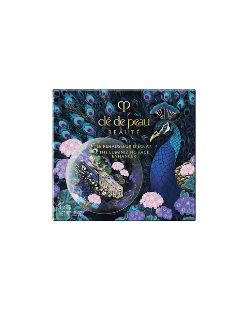 Photo of the outer box of the limited-edition THE LUMINIZING FACE ENHANCER Radiant Peafowl, decorated with peacocks, hydrangeas, and vibrant floral details.