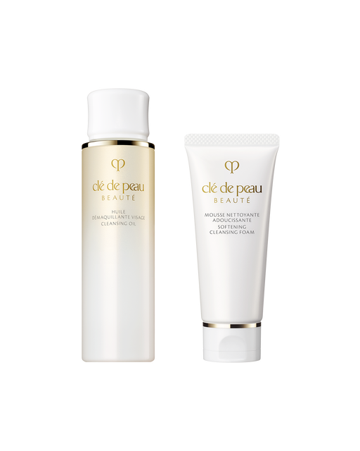 Photo of the mini set of “CLEANSING OIL” and “SOFTENING CLEANSING FOAM.” On the left is a 75mL cleansing oil in a bottle with a gold gradient and a white cap; on the right is a 40g softening cleansing foam in a white tube.