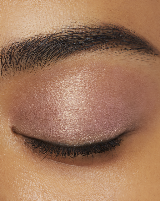 Photo of a deept skin tone model  wearing EYE COLOR SOLO in 101-Pink Ocean Dawn on the eyes.
