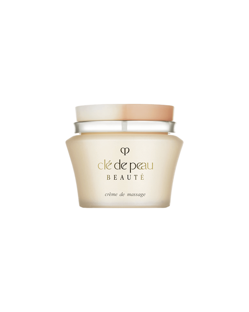 Photo of "MASSAGE CREAM" in a pale gold glass jar with a two-tone beige and white lid. The gold brand logo and product name are printed on the front.