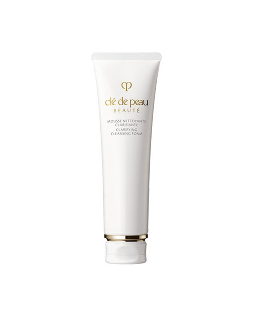 Photo of a white tube of “CLARIFYING CLEANSING FOAM.” Gold brand logo and product name are printed on the front. The cap features gold detailing. Size: 140g.