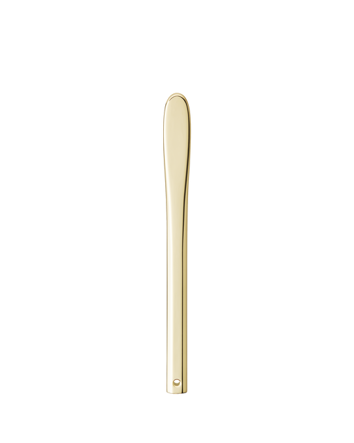 Photo of a simple yet elegant gold-colored spatula for applying cream.