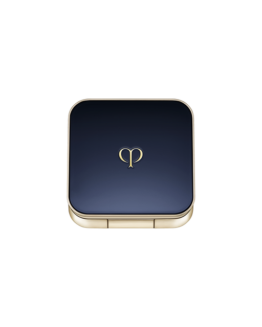 Photo of an exclusive case for "EYE COLOR SOLO" with the lid closed. It has a rounded square shape, with a blue-black lid featuring the brand logo in the center and gold trim along the sides.