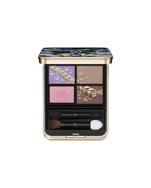 Photo of the limited-edition EYE COLOR QUAD, an eyeshadow consisting of four shades. The upper left and lower right shades are embossed with a gold train and motif, while the lower left shade features the brand logo. Shade: Pastel Tea Safari.