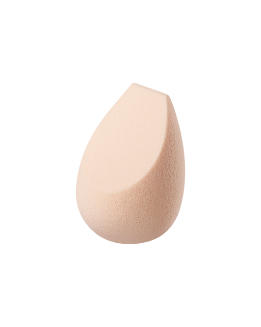 Photo of “THE SPONGE.” It is teardrop-shaped with a slanted tip and a fine texture.