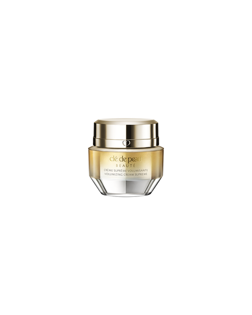 A photo of a jar of "VOLUMIZING CREAM SUPREME", featuring a gold and crystal-like design. SIZE : 15g