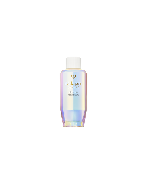 Photo of a refill bottle of THE SERUM, featuring an iridescent, aurora-inspired design with a white cap attached. SIZE: 50ml (refill)