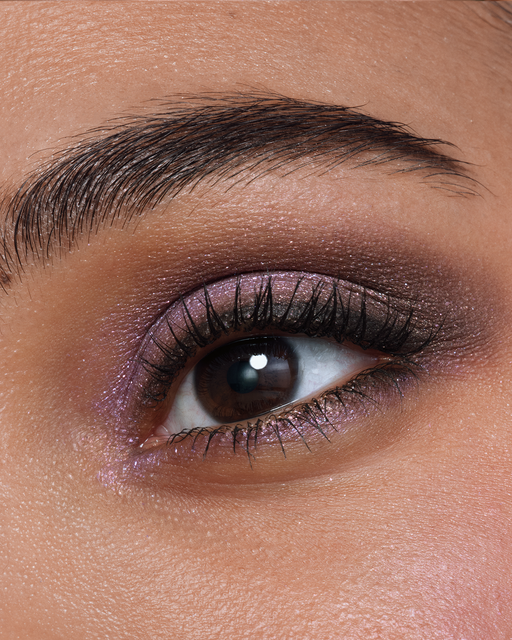 Photo of a deep skin tone model  wearing EYE COLOR QUAD in Pastel Tea Safari on the eyes.