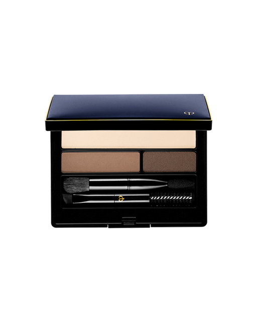 Photo of "EYEBROW AND EYELINER COMPACT". The compact contains three shades of powder, along with a brush, a spoolie brush, and an applicator tip. The lid is blue-black with a gold-engraved brand logo. Shade: 1-RD-BR.