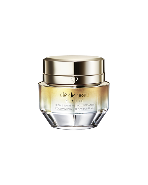 A photo of a jar of "VOLUMIZING CREAM SUPREME", featuring a gold and crystal-like design. SIZE: 50g