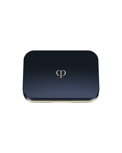 Photo of an exclusive case for "RADIANT POWDER FOUNDATION (REFILL)" with the lid closed. The lid is blue-black with the brand logo placed in the center.
