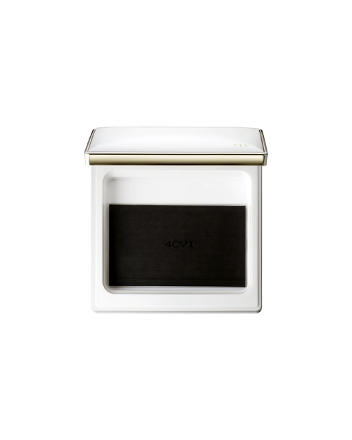 Photo of a case for "BRIGHTENING POWDER FOUNDATION". The lid of the white square compact is open and has the gold brand logo engraved on it on the bottom right corner.