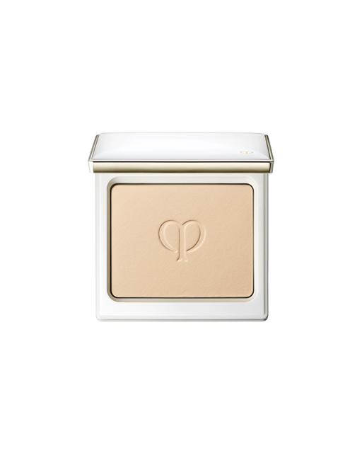 Photo of the powder foundation in a white compact case, with the brand logo embossed in the center.