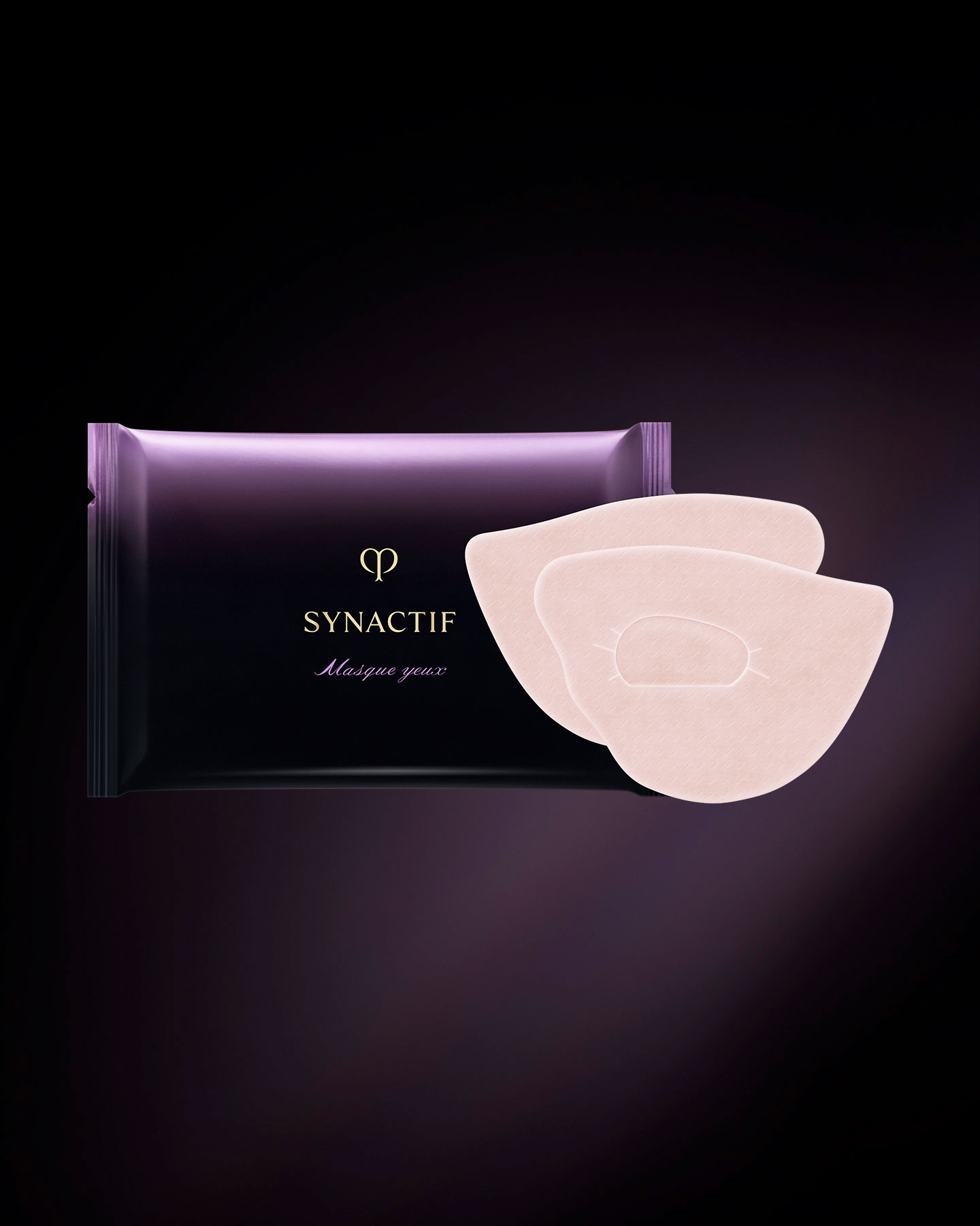 Photo of the Clé de Peau Beauté SYNACTIF EYE MASK. A pouch-style package with a black-to-purple gradient is displayed alongside two wide, smoothly curved eye masks in a pale beige color. Each mask has a central slit designed to conform to the eye contour.