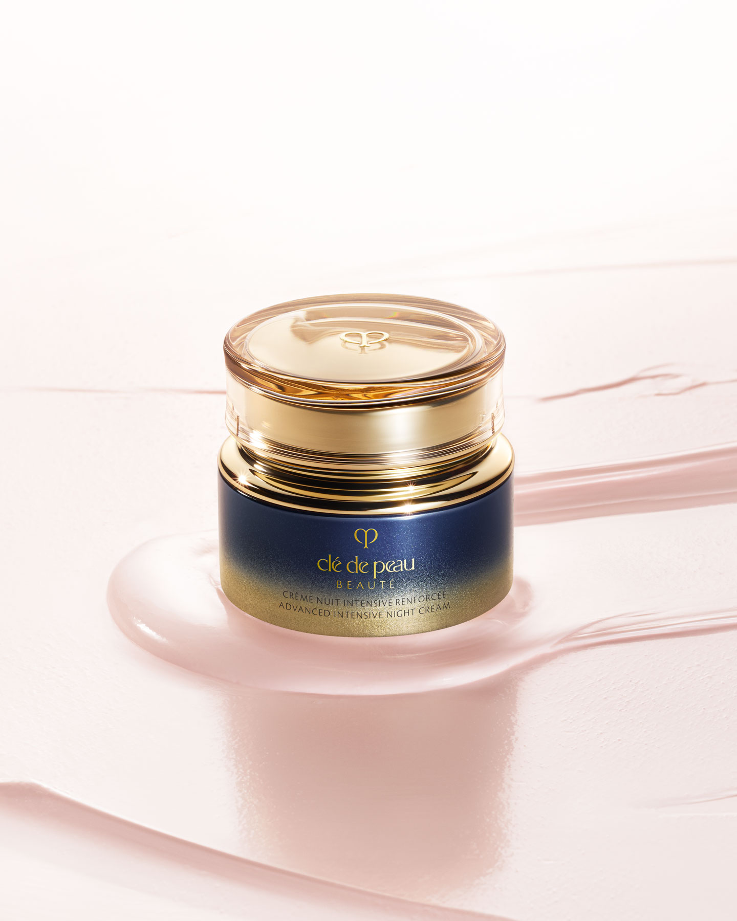 Photo of a ADVANCED INTENSIVE NIGHT CREAM jar with a rounded, translucent gold lid and a gradient design from dark blue to gold.
