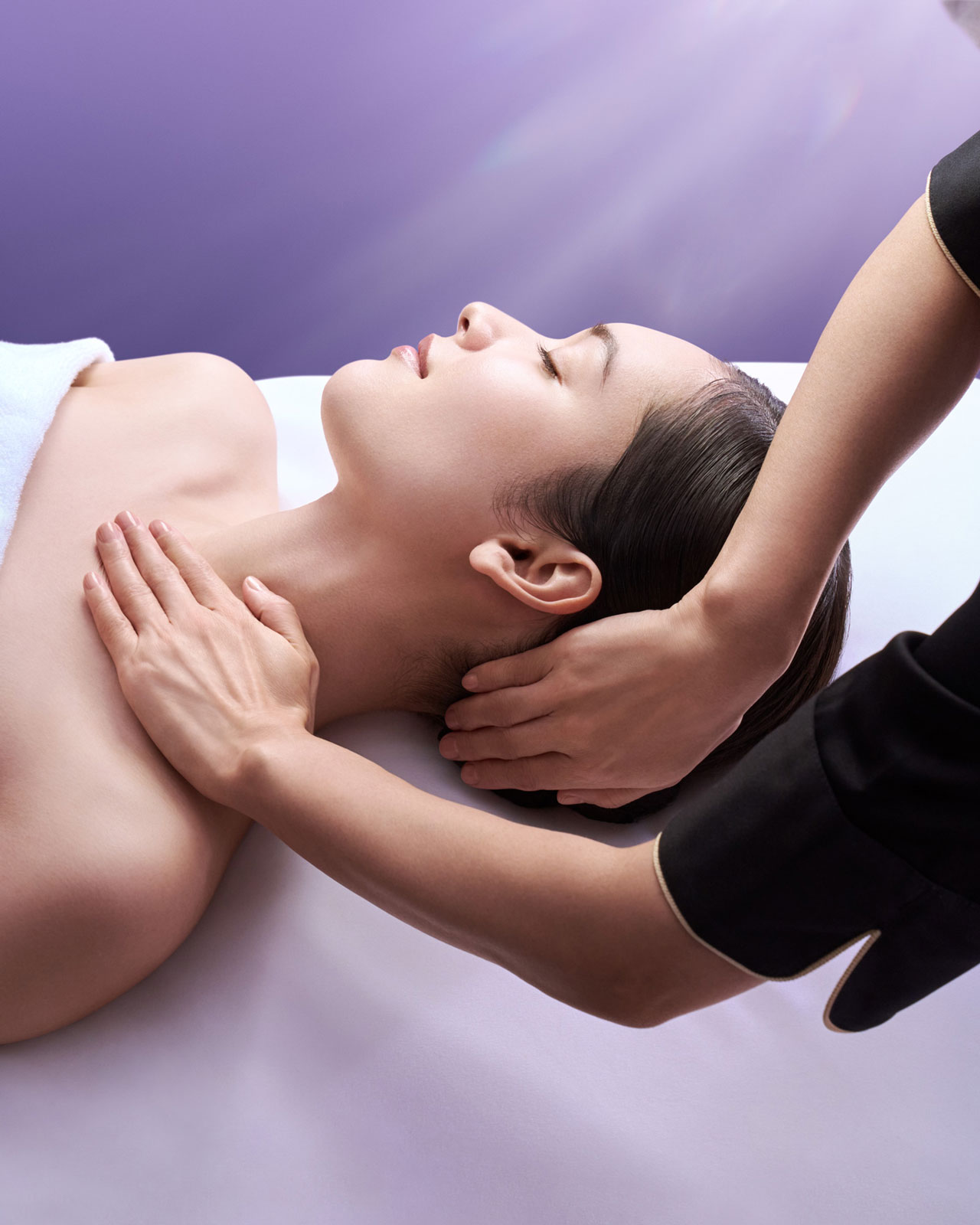 Photo of a woman relaxing while receiving a neck and shoulder massage.