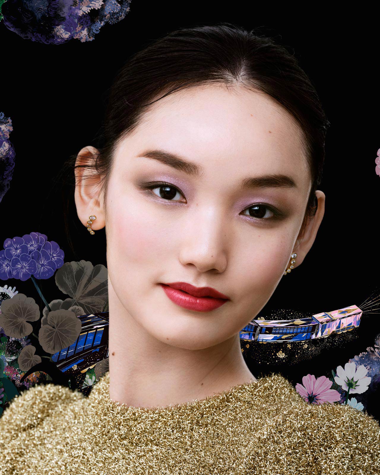Photo of a model wearing a gold top, with pink and purple eye makeup and red lipstick. Floral patterns and a train illustration appear in the background.