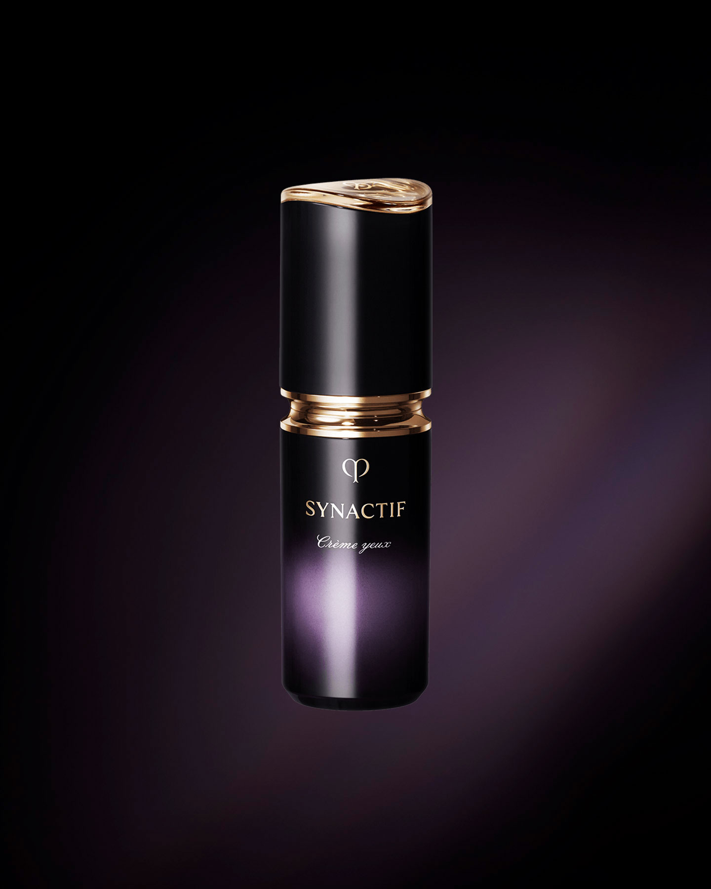 Photo of the Clé de Peau Beauté SYNACTIF EYE CREAM. It is housed in a compact cylindrical bottle featuring a black-to-purple gradient. A gold accent is placed between the cap and body, and the 'SYNACTIF' logo is displayed on the front.