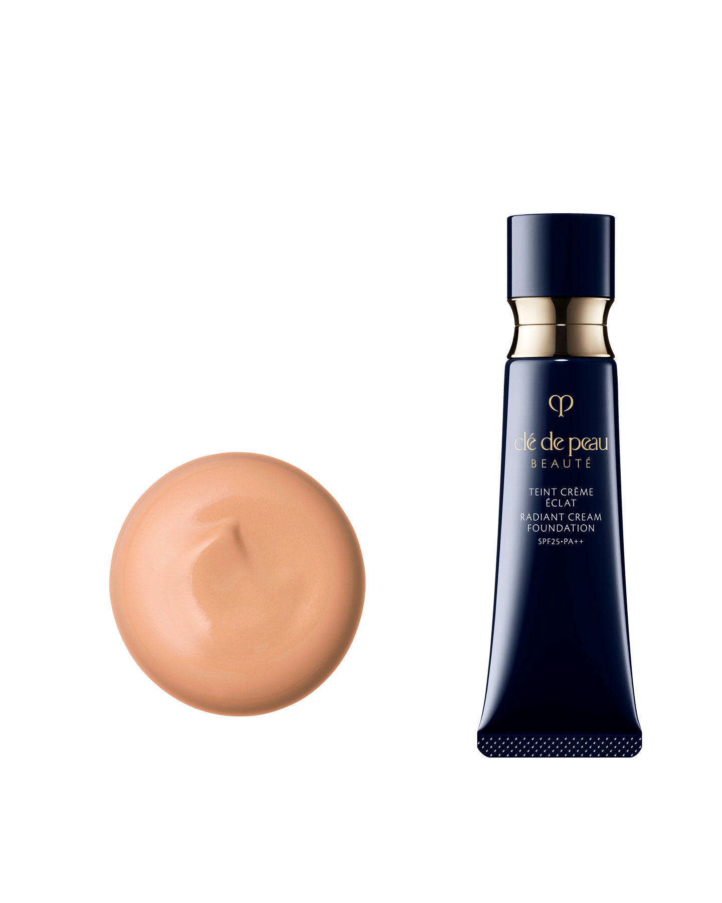 Photo of a blue-black tube of RADIANT CREAM FOUNDATION with gold accents and a smooth, creamy beige texture.
