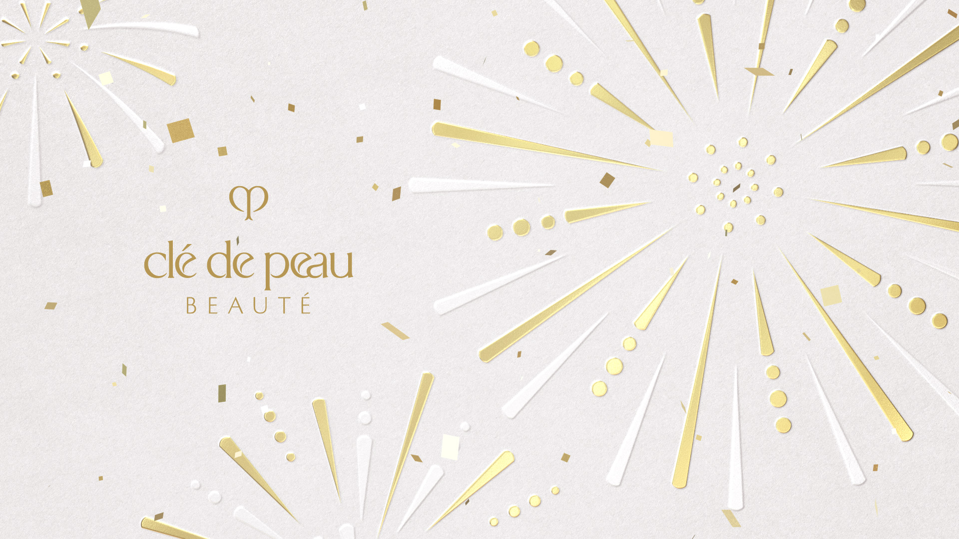 Wallpaper of the Clé de Peau Beauté logo with a gold fireworks design.