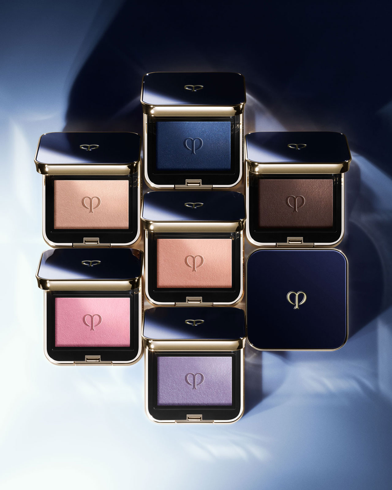 Photo of six open Eye Color Solo palettes and one closed palette against a blue gradient background.