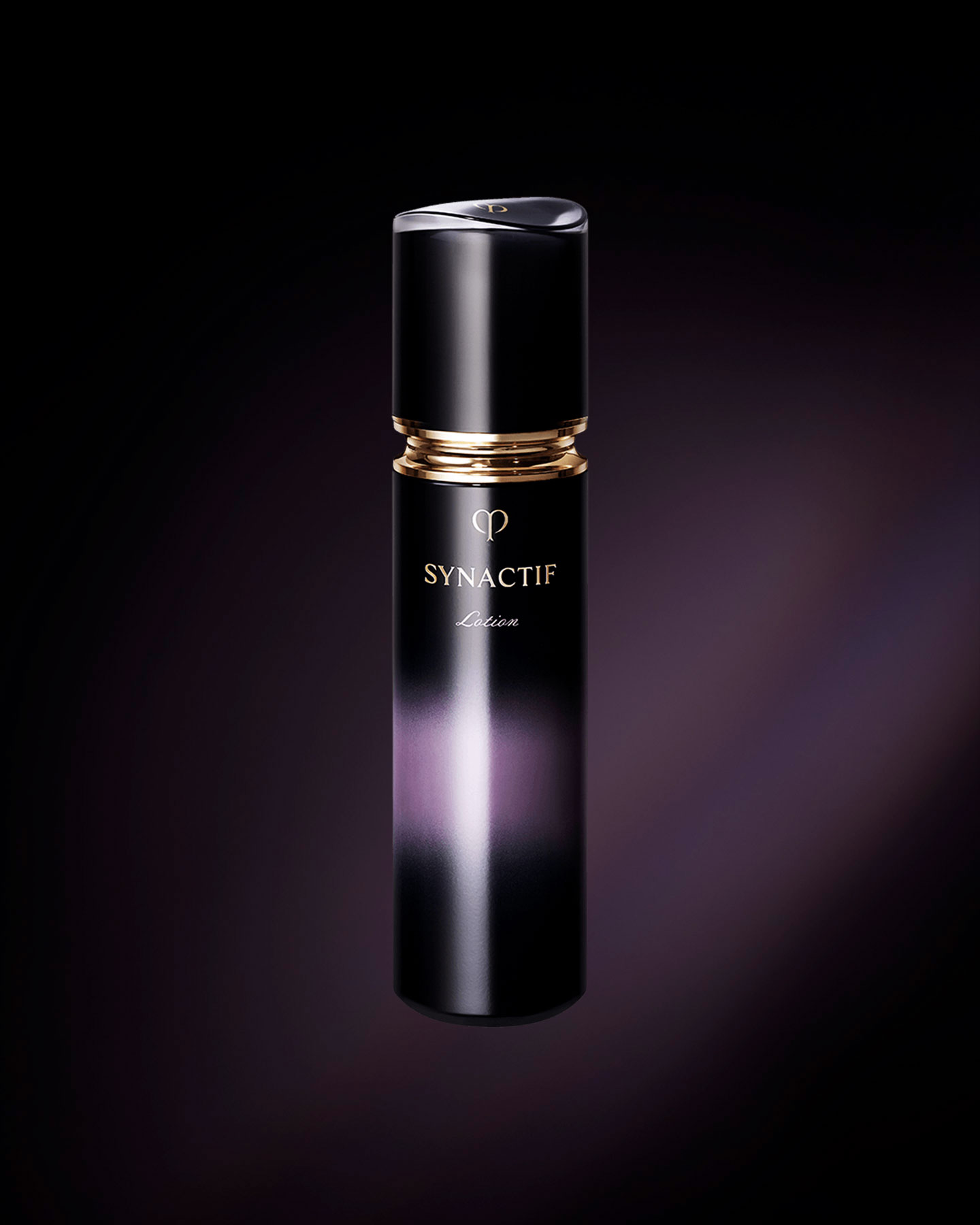 Photo of the sophisticated Clé de Peau Beauté SYNACTIF LOTION. The product is presented in a sleek, deep purple bottle that features a luminous gradient down the center, highlighted by a chic gold accent below the cap.