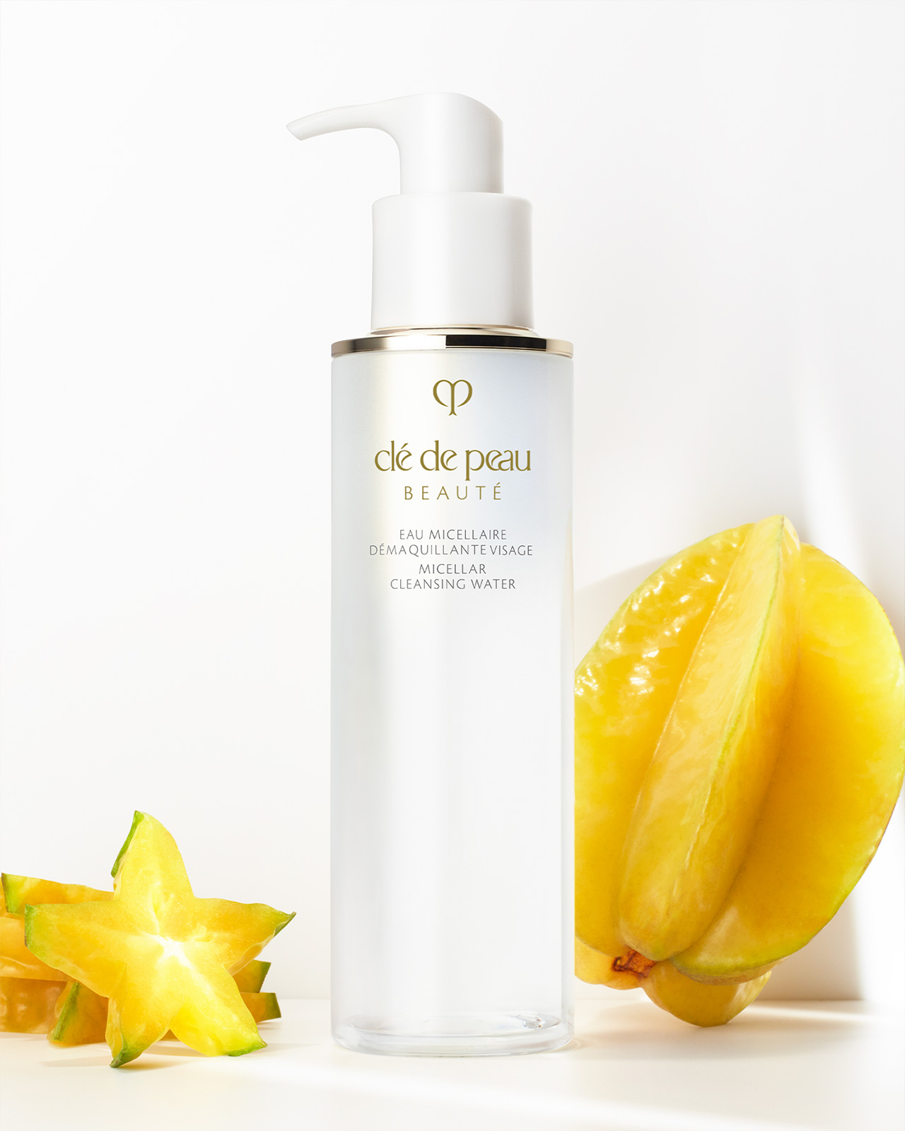 Photo of "MICELLAR CLEANSING WATER" placed alongside sliced starfruit on a white background.