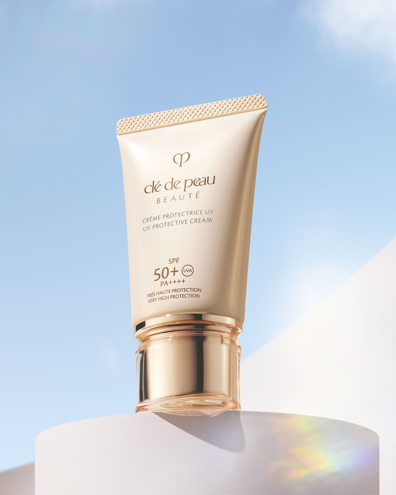 Photo of a UV PROTECTIVE CREAM in a glossy, cream-colored tube with a gold cap.