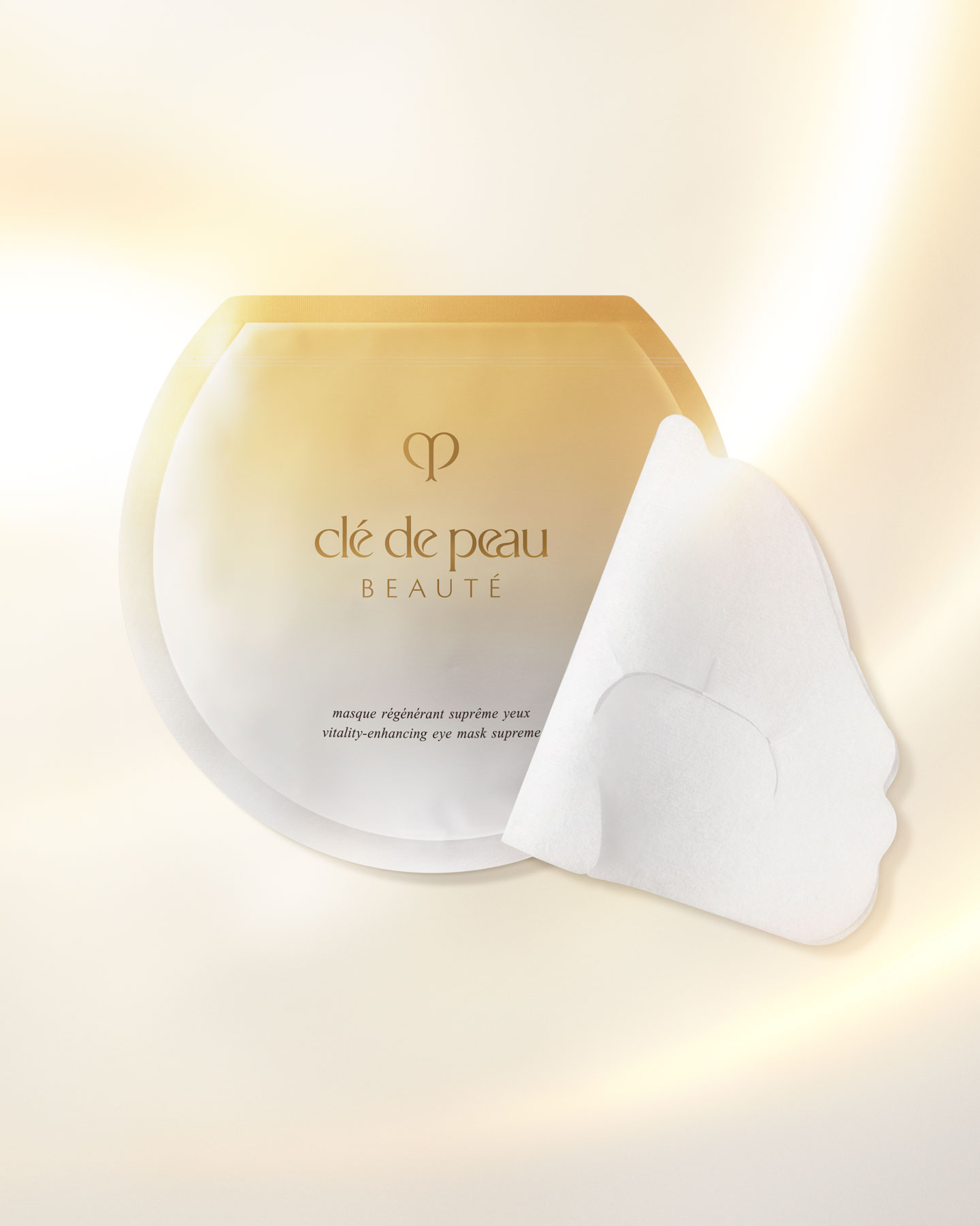 Photo of a VITALITY-ENHANCING EYE MASK SUPREME in a flat, glossy package featuring both gold and silver tones.
