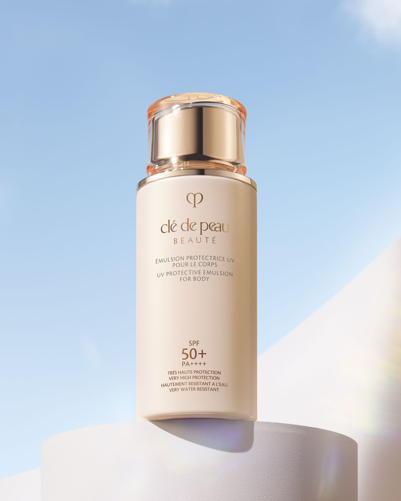 Photo of a UV PROTECTIVE EMULSION FOR BODY in a glossy, cream-colored bottle with a translucent, rounded gold cap.