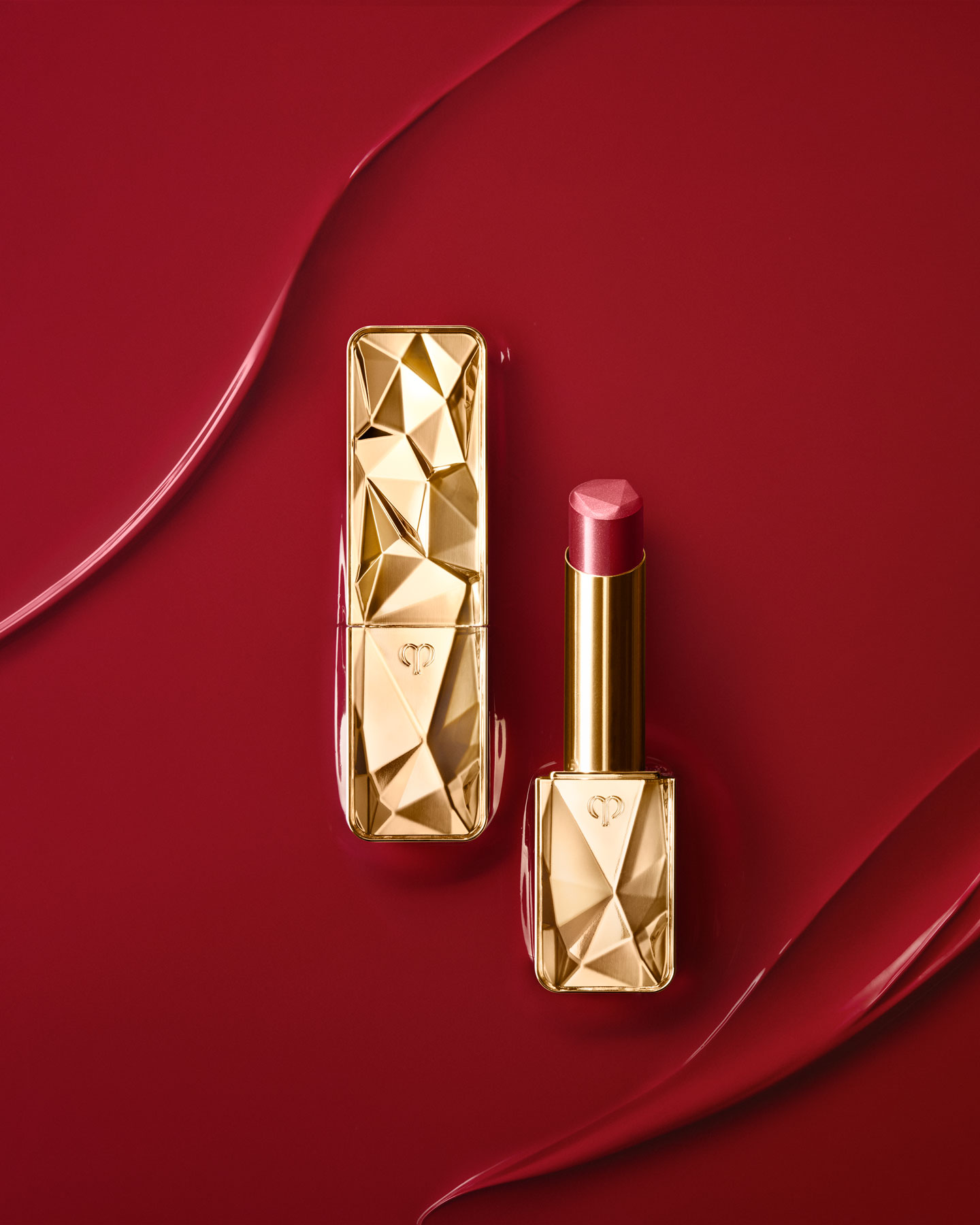 Photo of THE PRECIOUS LIPSTICK with a red hue, lustrous finish, and agold package featuring jewel-like faceting:3 3 Dynamic Ruby